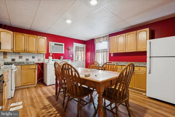 a dining room with a wooden table and chairs