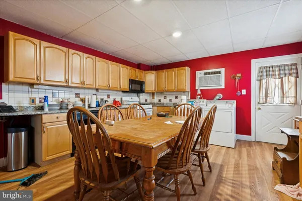 a dinning table and chairs in a kitchen