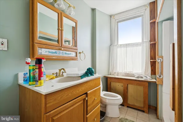 a bathroom with a sink a toilet and a window