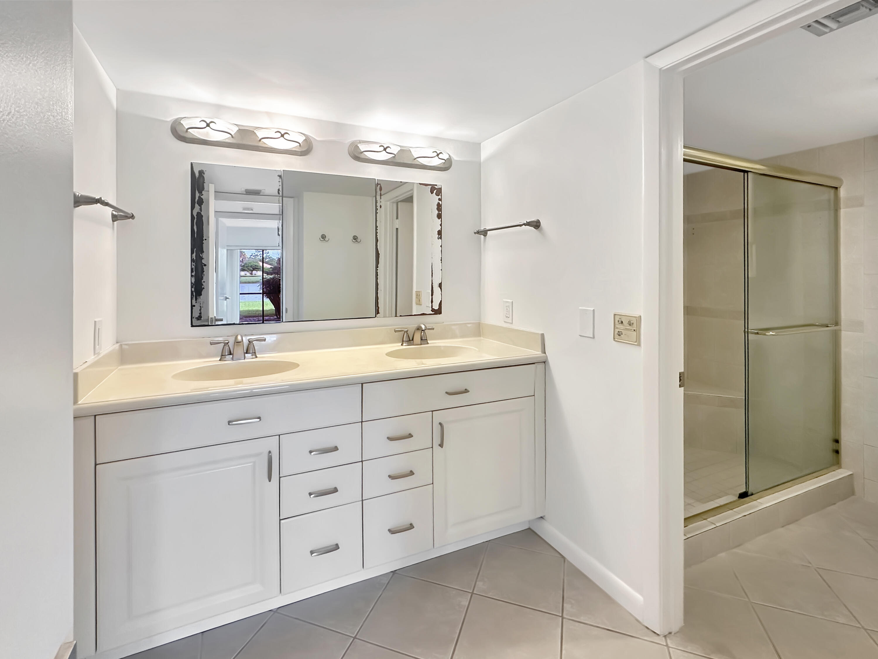 3351 Twin Lakes Terrace, Unit 102 Fort Pierce, FL 34951 - Photo 13 of 21 a bathroom with a double vanity sink mirror and double