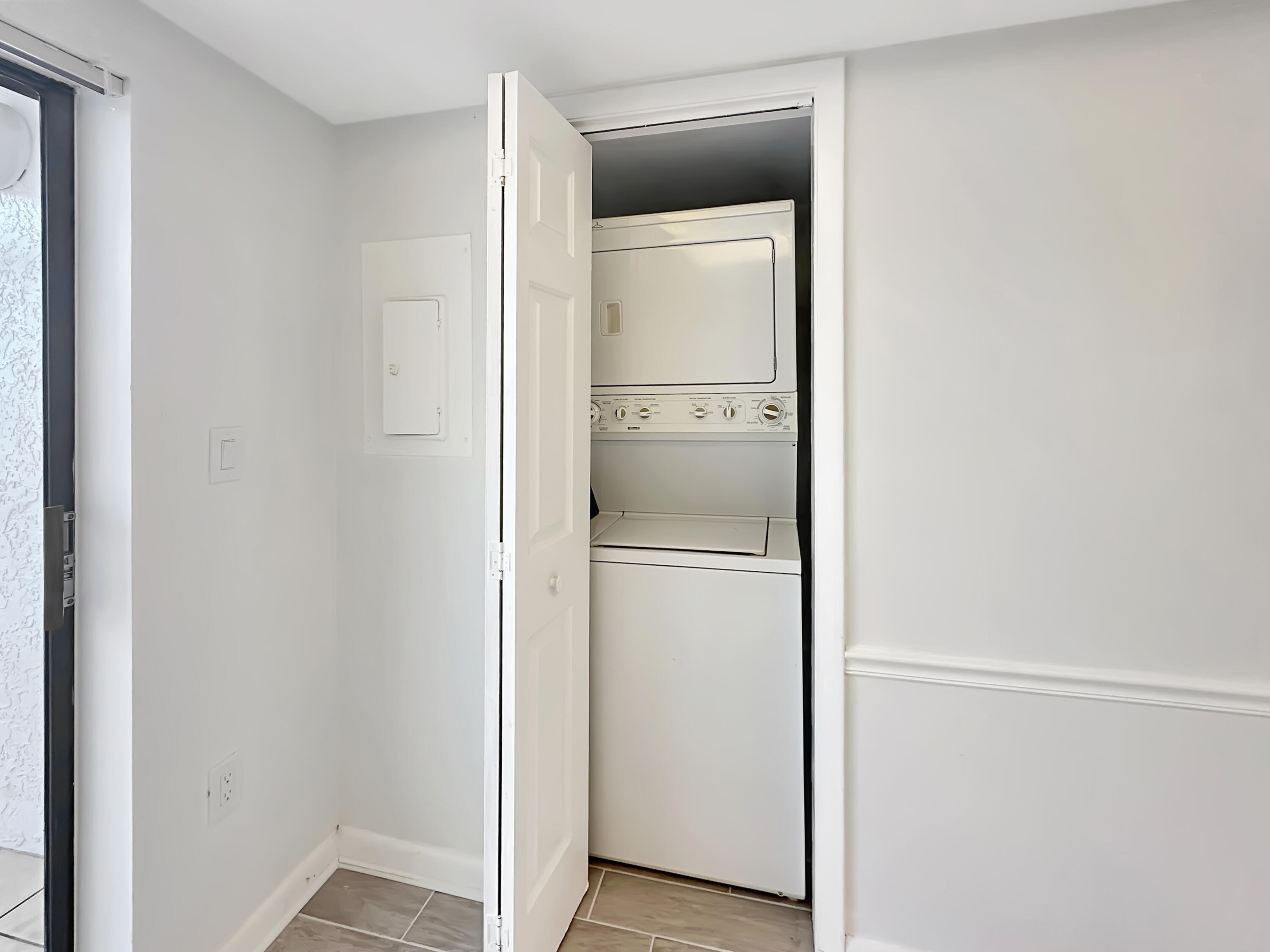 3351 Twin Lakes Terrace, Unit 102 Fort Pierce, FL 34951 - Photo 18 of 21 a room with a refrigerator and mirror