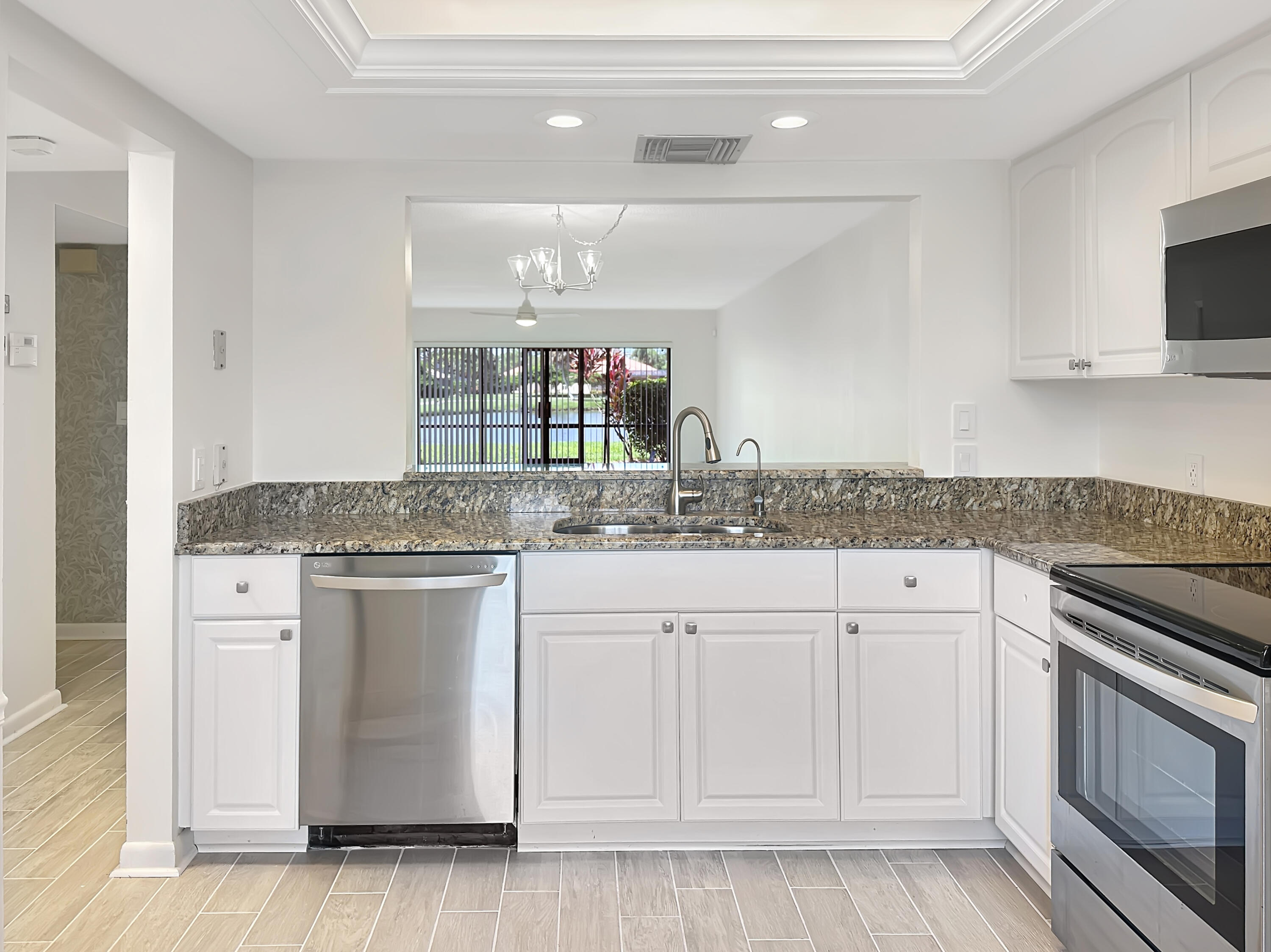 3351 Twin Lakes Terrace, Unit 102 Fort Pierce, FL 34951 - Photo 3 of 21 a kitchen with white cabinets and sink