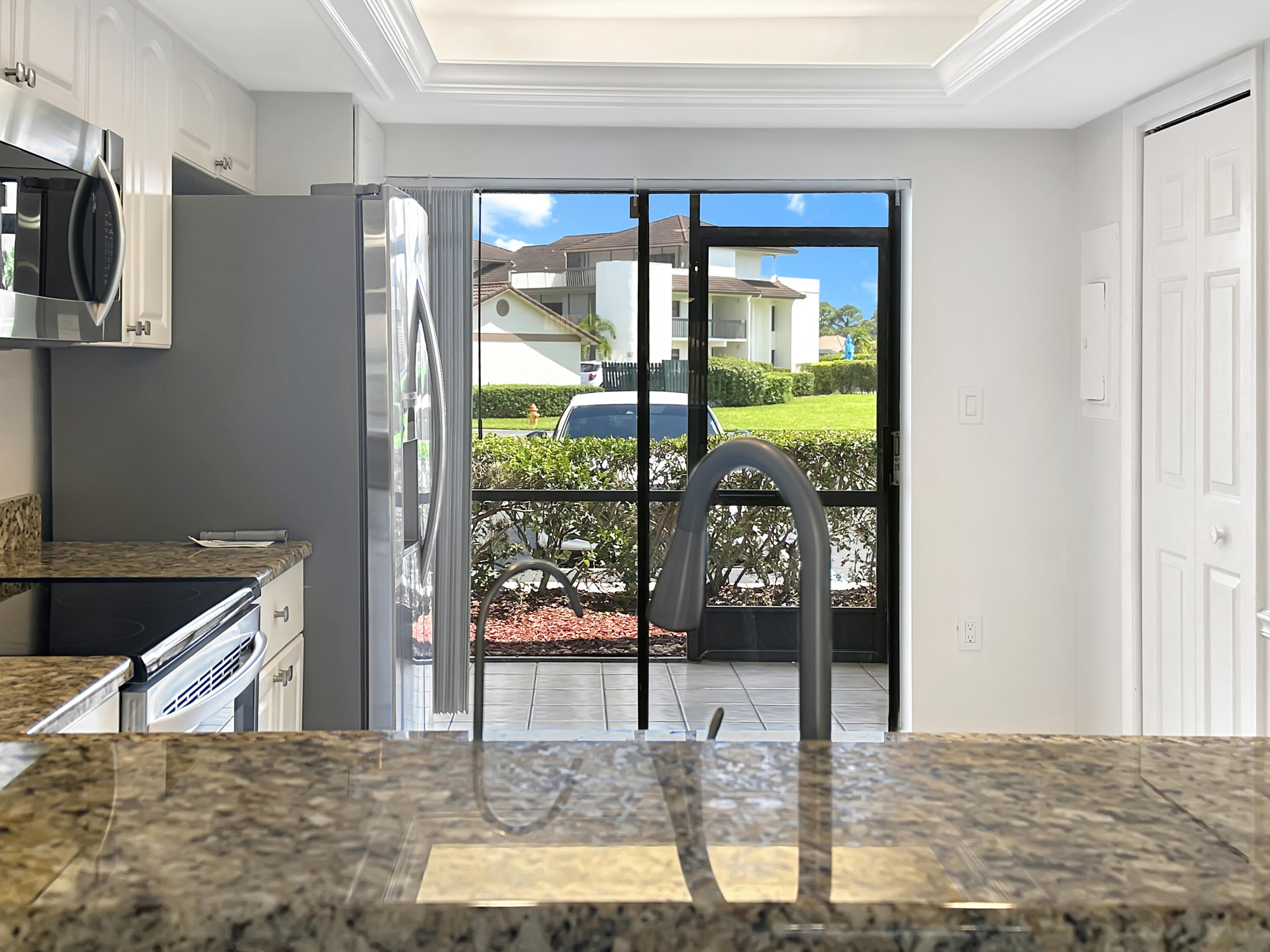 3351 Twin Lakes Terrace, Unit 102 Fort Pierce, FL 34951 - Photo 4 of 21 a view of a living room and floor to ceiling window