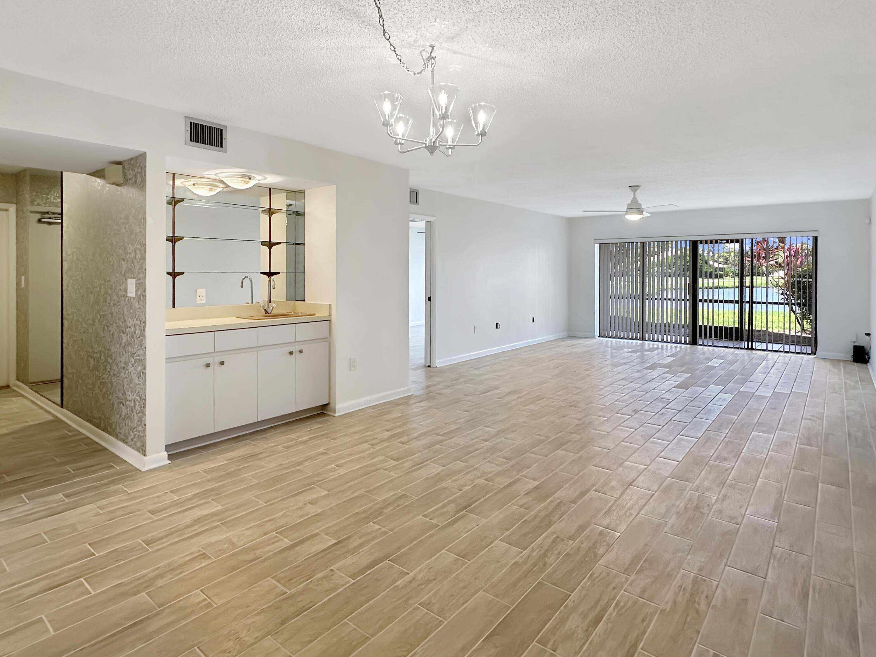 3351 Twin Lakes Terrace, Unit 102 Fort Pierce, FL 34951 - Photo 6 of 21 an empty room with kitchen and windows