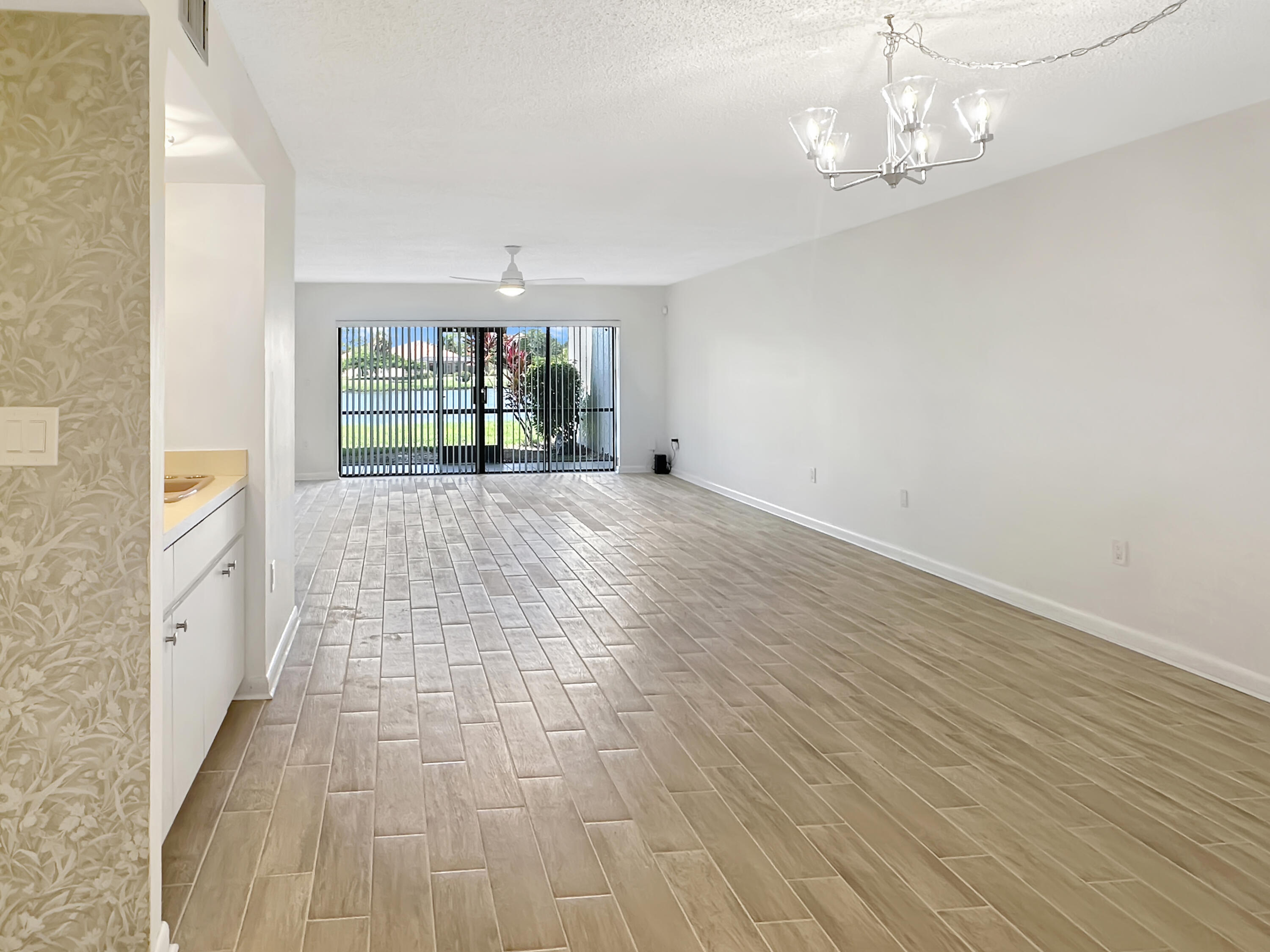 3351 Twin Lakes Terrace, Unit 102 Fort Pierce, FL 34951 - Photo 8 of 21 a view of empty room with wooden floor and fan