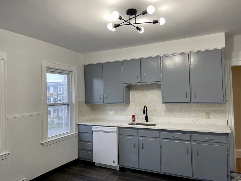18 Appleton Street, Unit 2 Quincy, MA 02171 - Photo 2 of 9 a kitchen with stainless steel appliances granite countertop a sink and dishwasher a stove with wooden floor