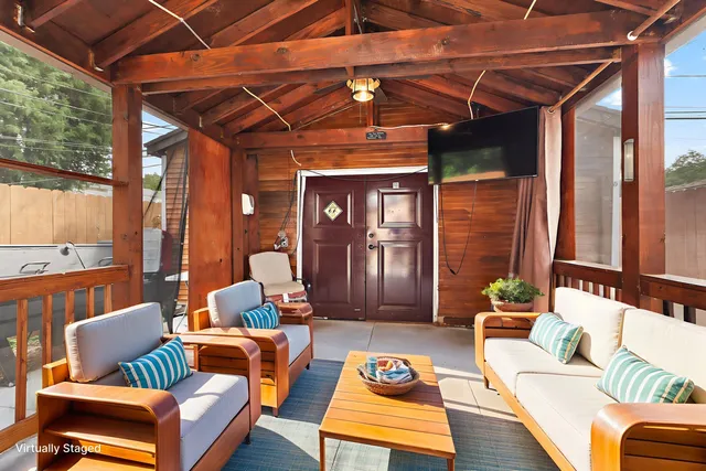 a view of porch with a table and chairs