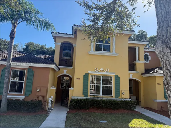 a front view of a house with yard and seating area