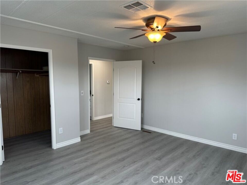 9391 California Avenue, Unit 89 Riverside, CA 92503 - Photo 11 of 16 a view of an empty room with wooden floor