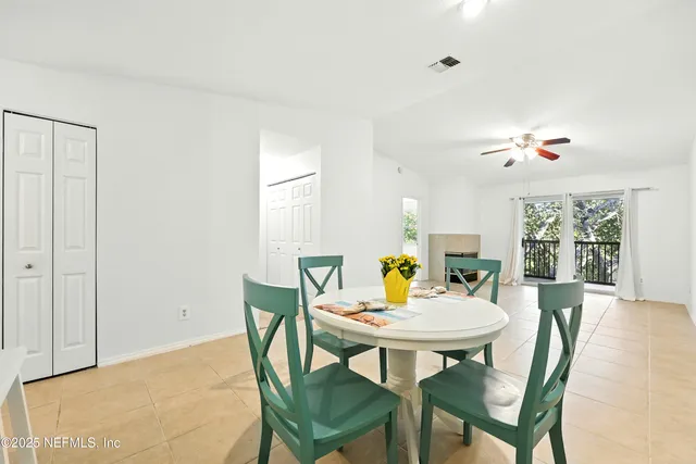 a view of a dining room with a table and chairs