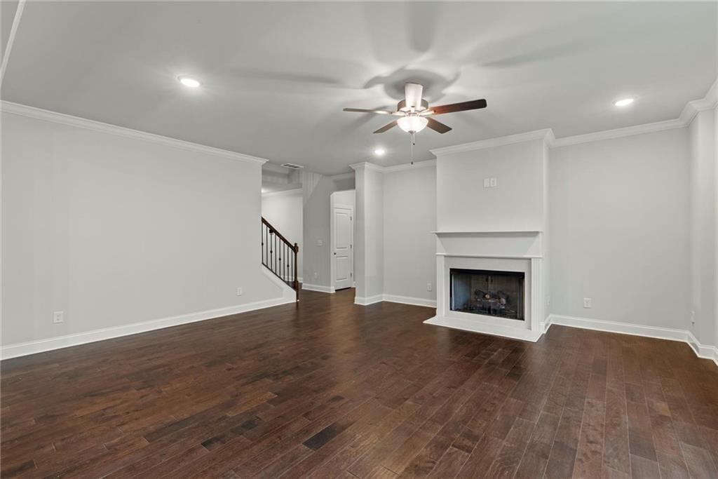 3455 Spring Pl Court Loganville, GA 30052 - Photo 11 of 42 a view of an empty room with wooden floor fireplace and a window