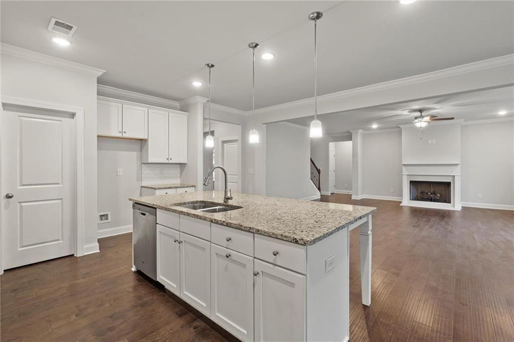 3455 Spring Pl Court Loganville, GA 30052 - Photo 14 of 42 a kitchen with a sink chandelier and a stove