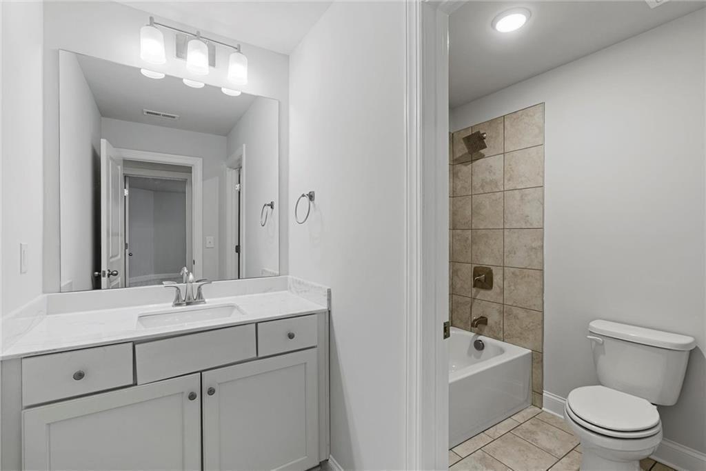 3455 Spring Pl Court Loganville, GA 30052 - Photo 29 of 42 a bathroom with a sink a toilet and shower