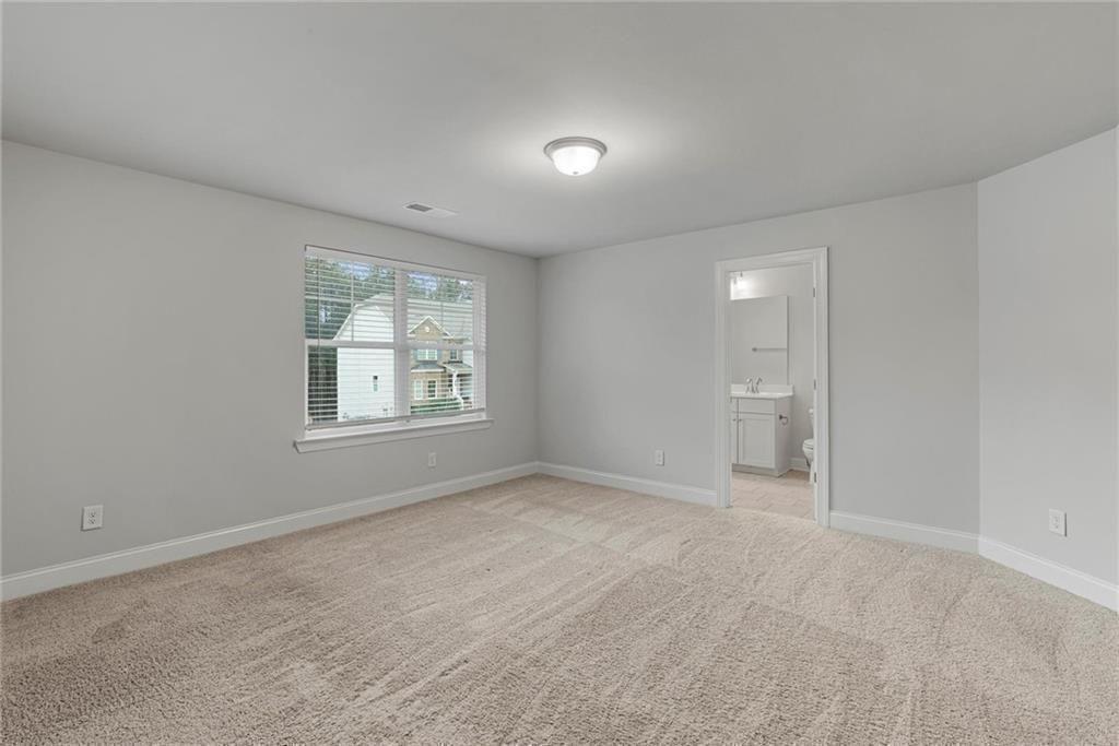 3455 Spring Pl Court Loganville, GA 30052 - Photo 30 of 42 a view of an empty room with a window and a bathroom