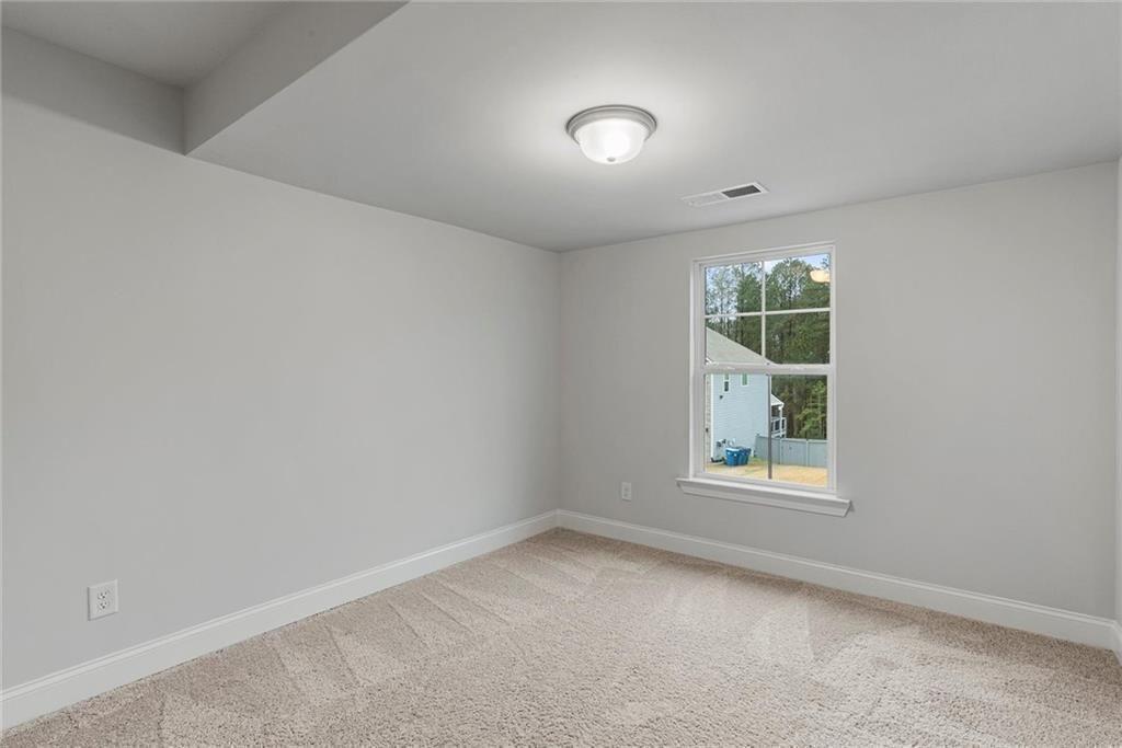 3455 Spring Pl Court Loganville, GA 30052 - Photo 33 of 42 an empty room with windows and entrance