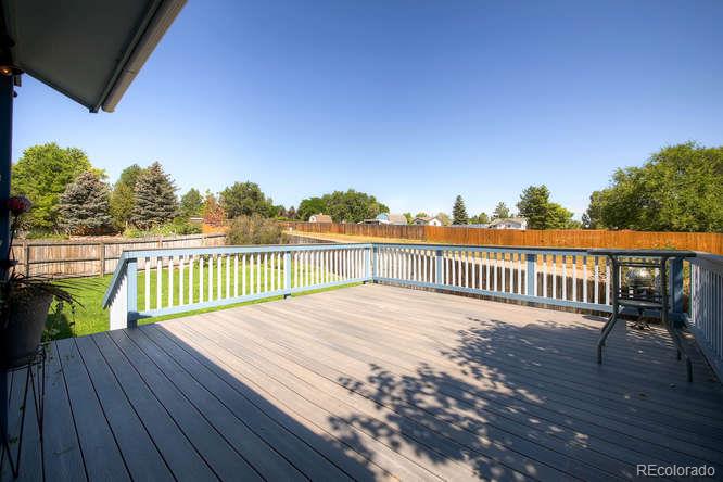 8205 Sweet Water Road Lone Tree, CO 80124 - Photo 23 of 33 a view of a deck with wooden floor and fence with a bench