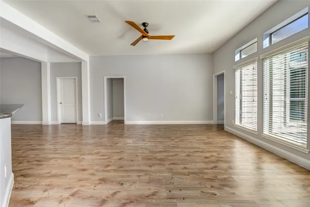 a view of a livingroom with a ceiling fan and window