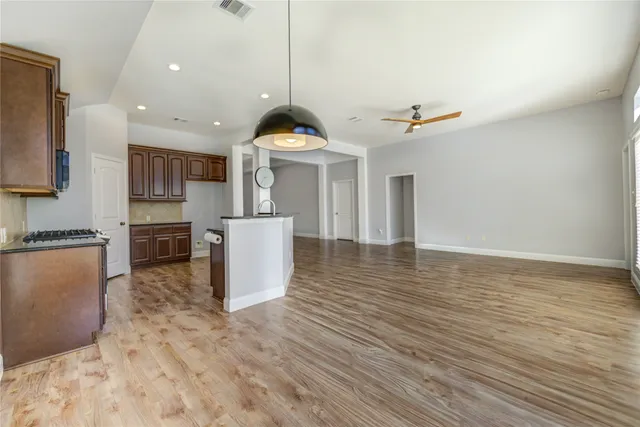 a view of a kitchen with a sink and a refrigerator