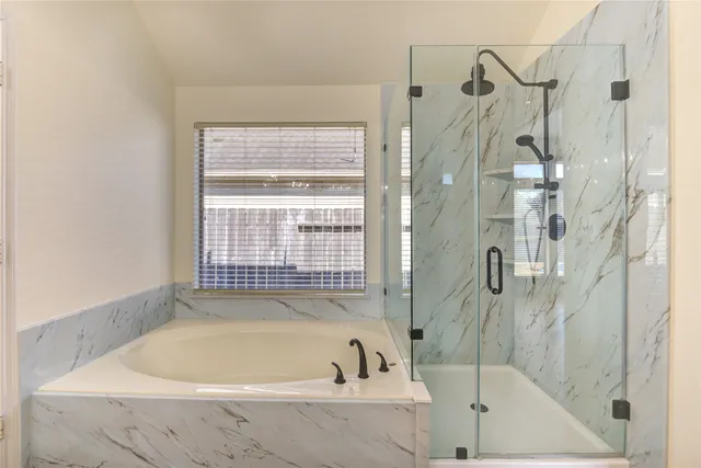 a bathroom with a bathtub and a shower