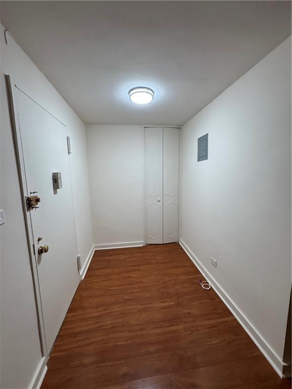 1165 East 54th Street, Unit 2Z Brooklyn, NY 11234 - Photo 5 of 14 an empty room with wooden floor and sliding door