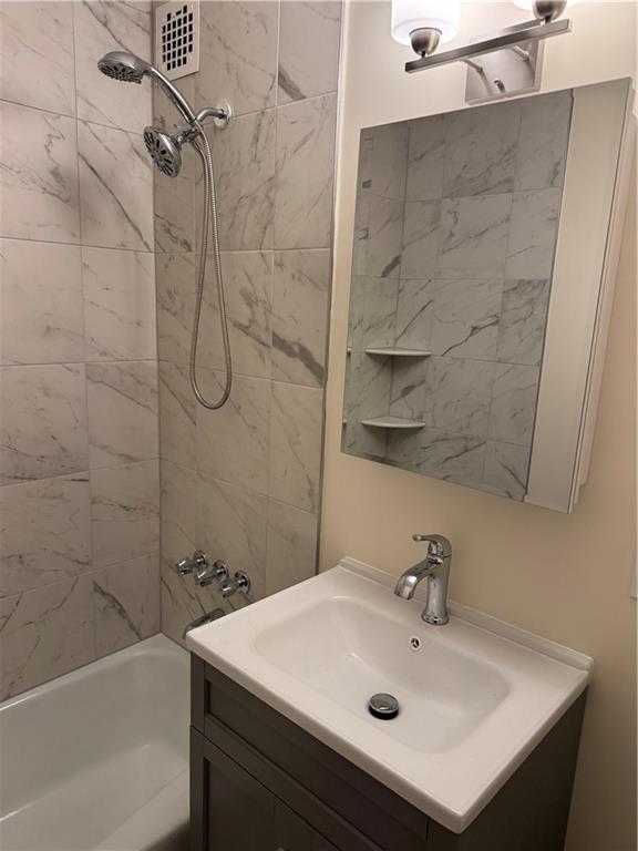 1165 East 54th Street, Unit 2Z Brooklyn, NY 11234 - Photo 9 of 14 a bathroom with a white sink a shower and vanity