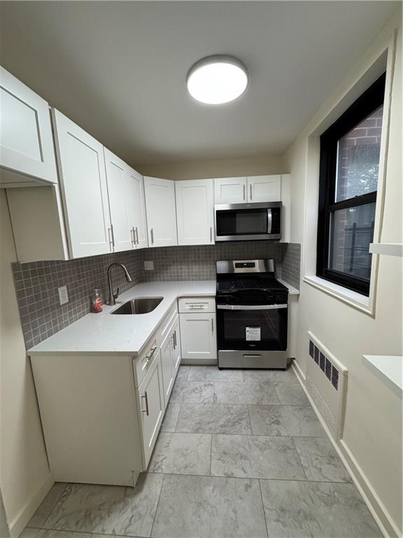 1165 East 54th Street, Unit 2Z Brooklyn, NY 11234 - Photo 10 of 14 a kitchen with a sink and a stove top oven
