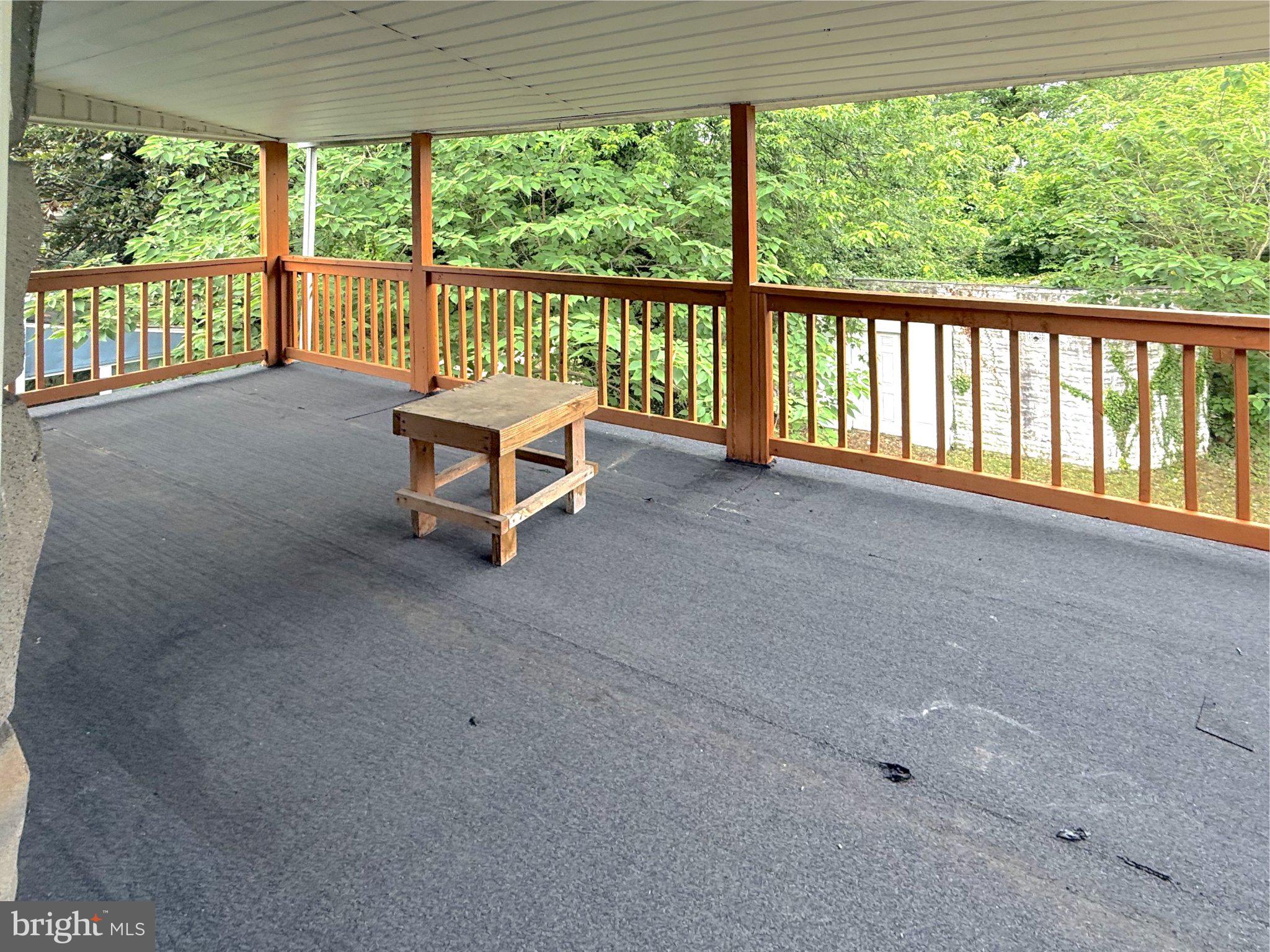 304 Collins Avenue, Unit 2 Baltimore, MD 21229 - Photo 9 of 17 Spacious deck with serene greenery views.