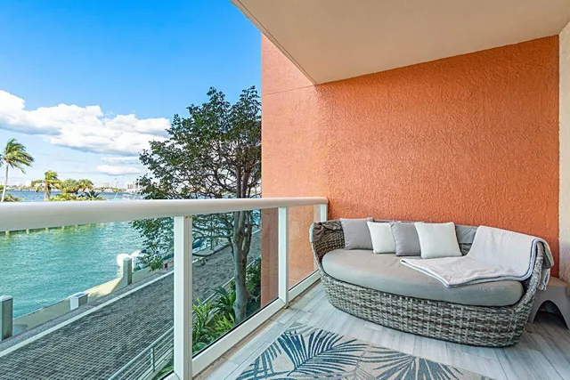 a balcony with furniture and a lake view