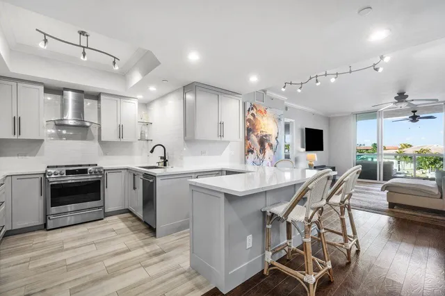 a kitchen with stainless steel appliances kitchen island granite countertop a sink and cabinets