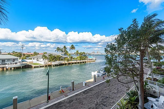 a view of a patio with a table and chairs under an umbrella