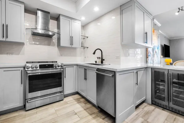 a kitchen with stainless steel appliances granite countertop a sink stove and cabinets