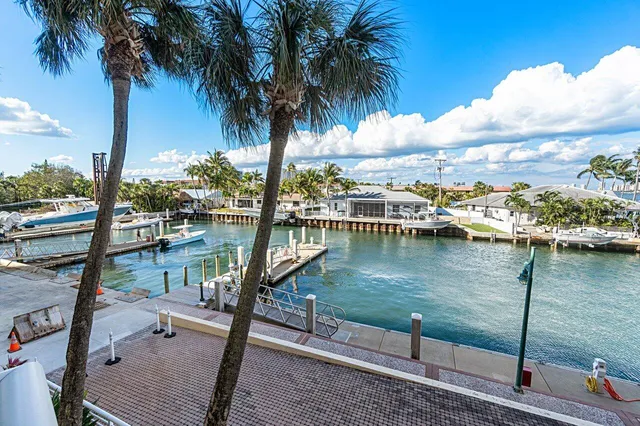 a large dining space with furniture a rug a flat screen tv and a clock