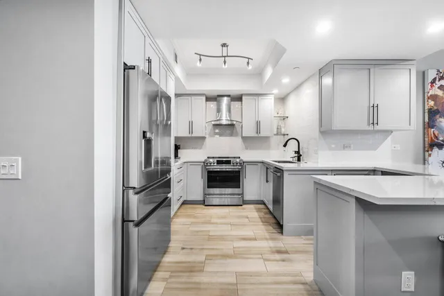 a kitchen with stainless steel appliances granite countertop a sink and cabinets