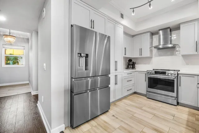a kitchen with a white cabinets and stainless steel appliances
