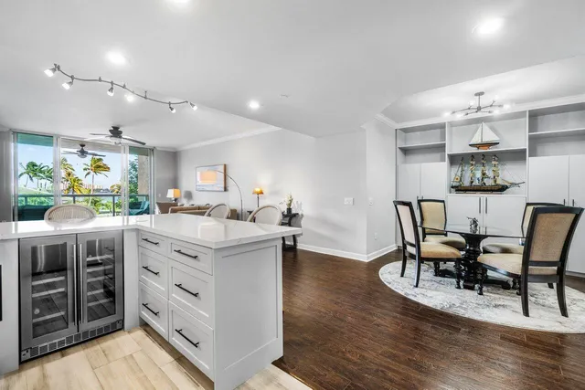 a kitchen with a table chairs and wooden floor