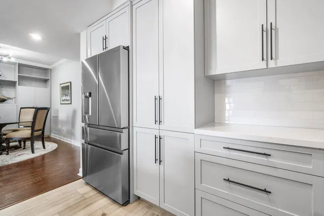 a kitchen with stainless steel appliances a refrigerator and cabinets