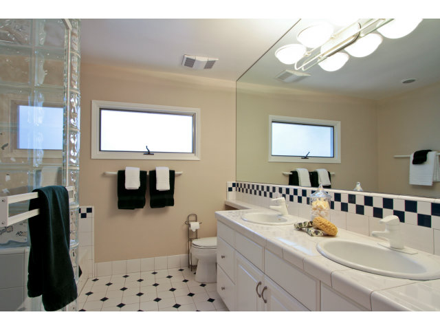 205 Galli Drive Los Altos, CA 94022 - Photo 14 of 20 a bathroom with a sink a toilet a mirror and shower