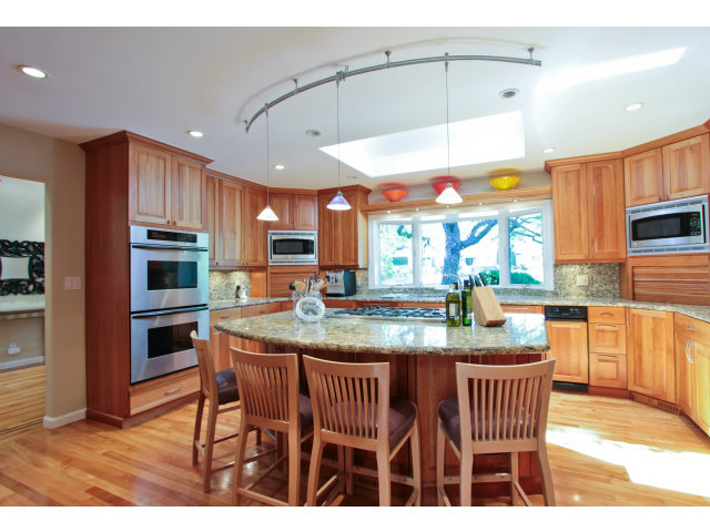 205 Galli Drive Los Altos, CA 94022 - Photo 7 of 20 a kitchen with stainless steel appliances granite countertop a kitchen island a stove a dining table and chairs with wooden floor