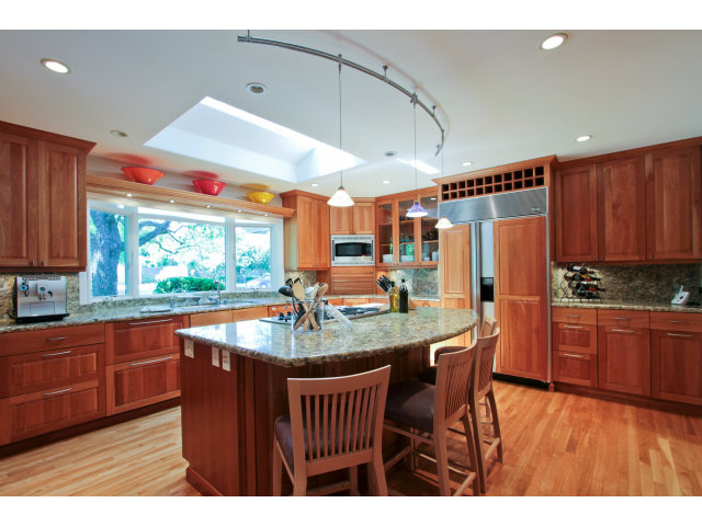 205 Galli Drive Los Altos, CA 94022 - Photo 8 of 20 a kitchen with stainless steel appliances granite countertop a sink a microwave and wooden cabinets