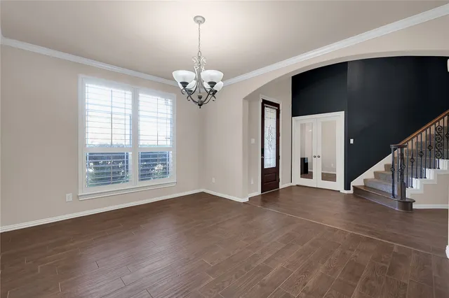 a kitchen with stainless steel appliances granite countertop a stove top oven a refrigerator a sink and dishwasher with wooden floor