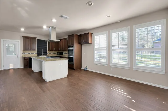 a kitchen with stainless steel appliances granite countertop a stove sink and cabinets