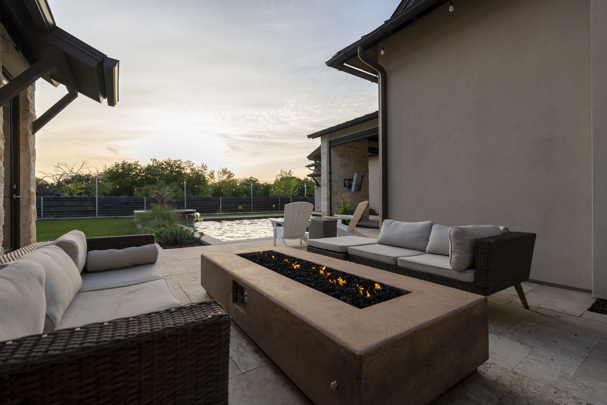16202 Remuda Trail Buda, TX 78610 - Photo 32 of 40 This property features an expansive outdoor patio with a fire pit, a swimming pool, and a well-maintained lawn