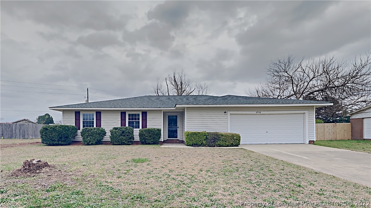 6536 Grist Mill Road Fayetteville, NC 28314 - Photo 1 of 20 a front view of a house with a yard and garage