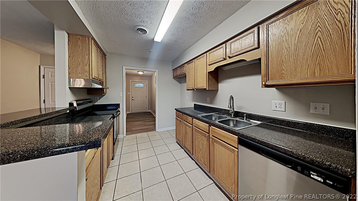 6536 Grist Mill Road Fayetteville, NC 28314 - Photo 11 of 20 a kitchen with granite countertop a stove and a sink