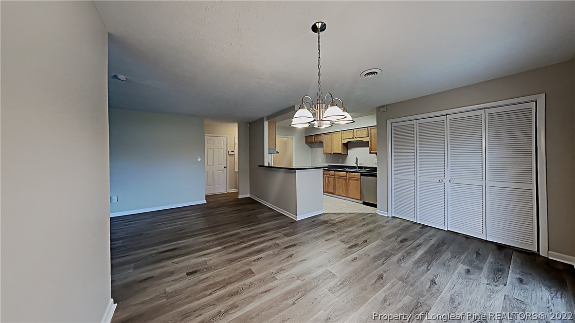 6536 Grist Mill Road Fayetteville, NC 28314 - Photo 3 of 20 a view of a room with wooden floor and kitchen view