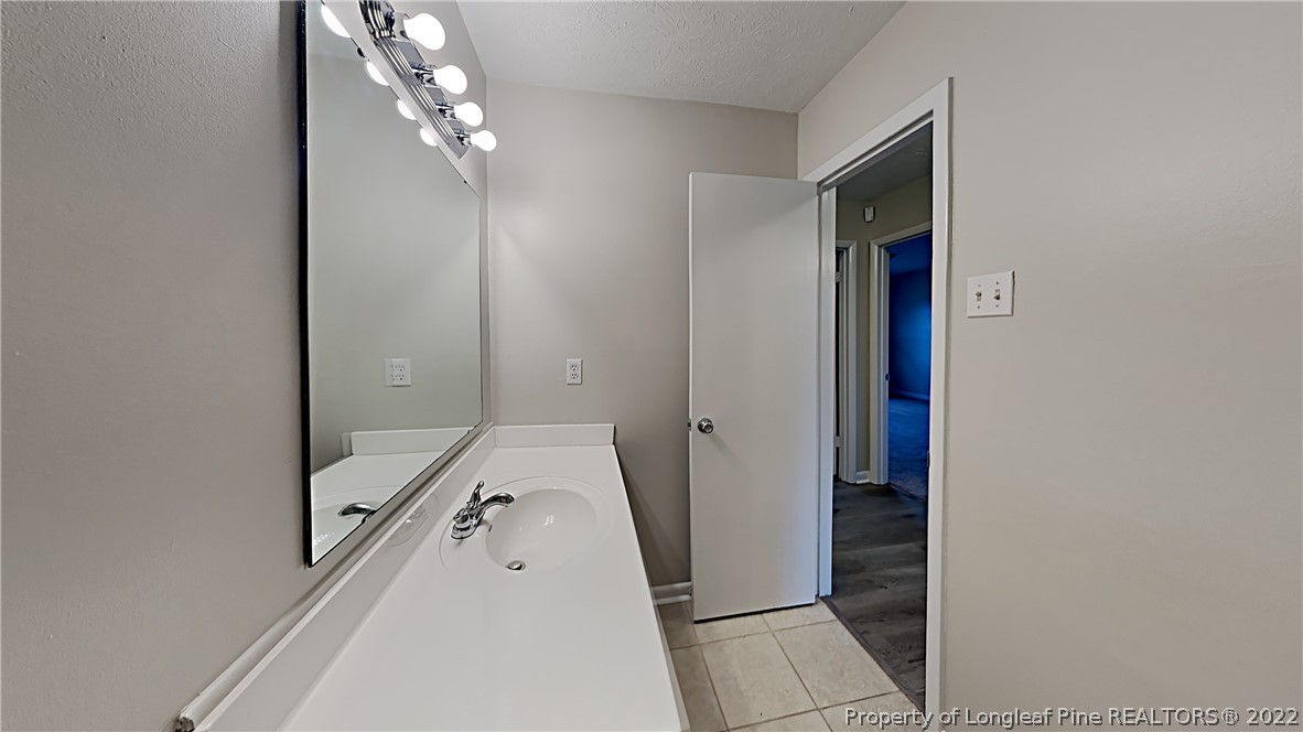 6536 Grist Mill Road Fayetteville, NC 28314 - Photo 6 of 20 a spacious bathroom with a double vanity sink and mirror