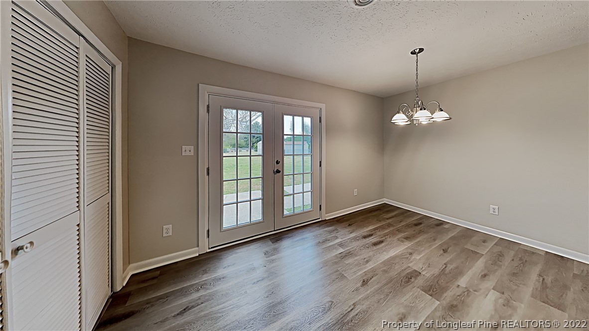 6536 Grist Mill Road Fayetteville, NC 28314 - Photo 10 of 20 a view of an empty room with wooden floor and a window