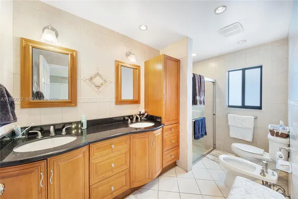 a spacious bathroom with a sink double vanity shower and a mirror