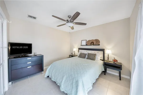 a bedroom with a bed and a television