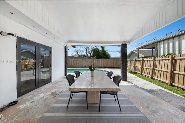 a view of a patio with a table and chairs